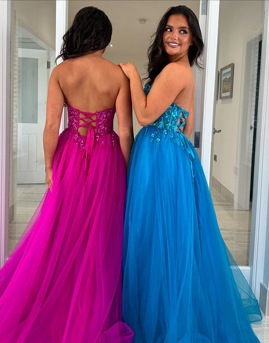 Robe de bal longue en tulle fuchsia sans bretelles avec appliques
