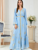 Robe dorée à la mode à manches longues et col en V